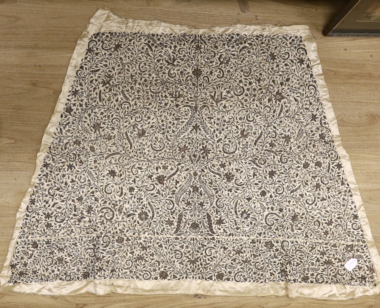 An Anglo-Indian, early Victorian ornate silver bullion, stump worked panel, on oyster satin silk, possibly a skirt panel to an evening gown, in three sections, the central panel 21 inches wide., 105cms long x 163cms at t